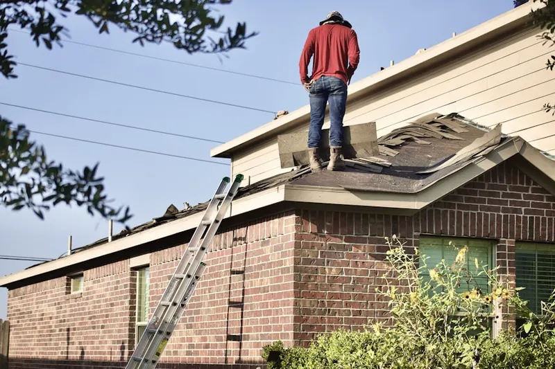 Professional roofer working on a residential roof in Midas